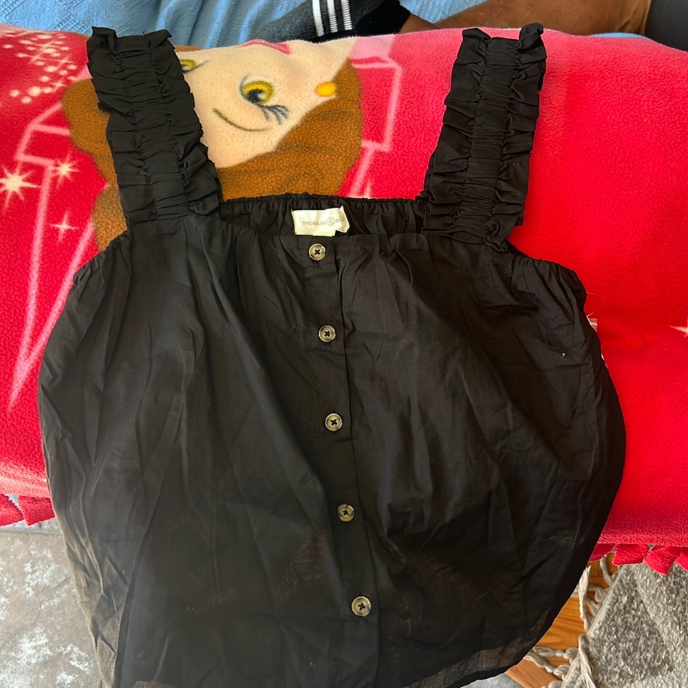 Black summer top over the shoulder straps.